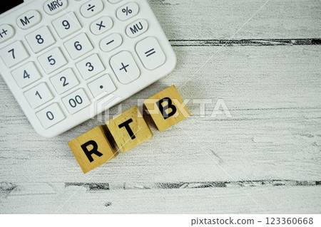 RTB (Real Time Bidding) text with alarm clock and calculator on wooden background 123360668