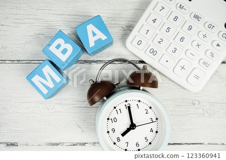 MBA (Master of Business Administration text with alarm clock and calculator on wooden background 123360941