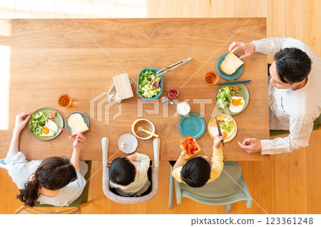 Young family eating at the table 123361248