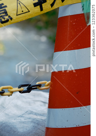 A traffic cone to warn of danger during a disaster A traffic cone to warn of danger during a disaster 123362075