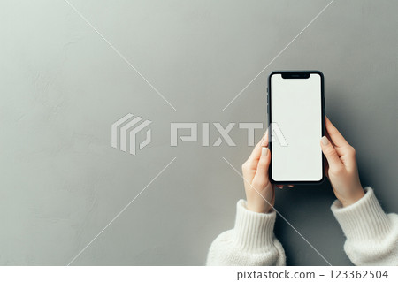 Person Holding Black Smartphone with Blank Screen on Gray Background, Modern and Stylish Design 123362504