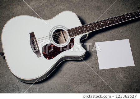 Top View of Acoustic Guitar on Gray Background with Blank Card for Music Concept and Design 123362527