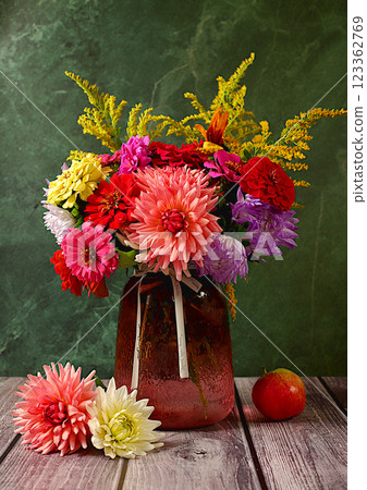 Beautiful still life with a bouquet of dahlias, asters, marigolds on an old marble table, autumn banner, abstract floral arrangement, rustic style, holiday card, selective focus. Beautiful still life with a bouquet of dahlias, asters, marigolds on an old marble table, autumn banner, abstract floral arrangement, rustic style, holiday card, selective focus. 123362769