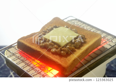 Toasting bread on a charcoal grill Toasting bread on a charcoal grill 123363025