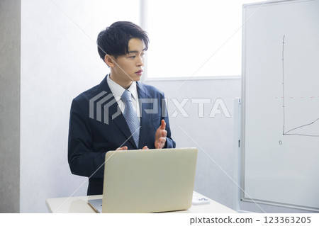 Young businessman presenting Young businessman presenting 123363205