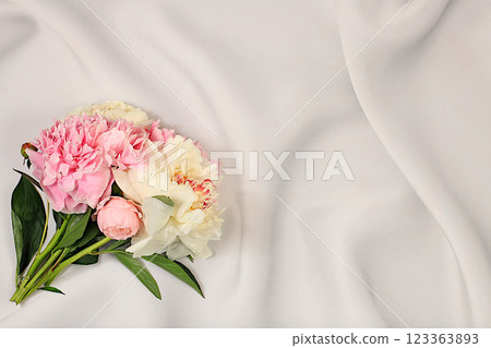 Abstract floral arrangement, flat lay, bouquet of beautiful peonies on an elegant background, spring and summer banner. Creative modern bouquet. Mother's Day card, happy birthday, wedding, holiday 123363893