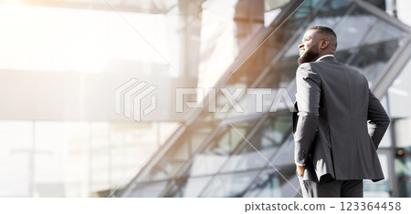Successful Business People. Black Businessman Relaxing Under Sun Walking In Urban Area. Back View, Copy Space 123364458