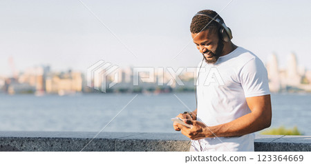 Young Black Jogger Setting Playlist On His Phone Before Exercising, staying on the bridge, copy space 123364669