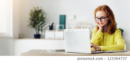 Remote Job Concept. Curly Red-Haired Woman In Specs Using Laptop Working At Home, Copy Space Remote Job Concept. Curly Red-Haired Woman In Specs Using Laptop Working At Home, Copy Space 123364737