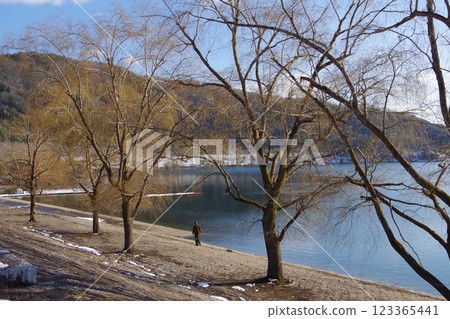 People walking around the dam lake People walking around the dam lake 123365441
