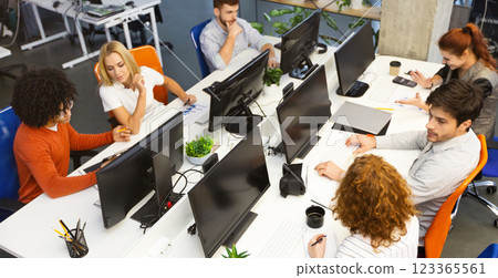 Group of young business people working together, sitting at coworking office, empty space 123365561