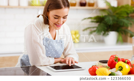 Young Woman Using Tablet For Cooking Vegan Food In Modern Kitchen, Panorama 123366030