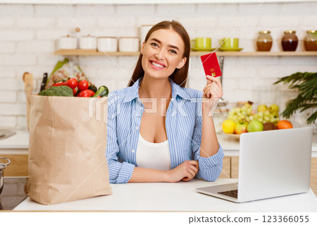 Online Grocery Shopping. Woman With Credit Card, Laptop And Vegetables In Craft Paper Bag Online Grocery Shopping. Woman With Credit Card, Laptop And Vegetables In Craft Paper Bag 123366055