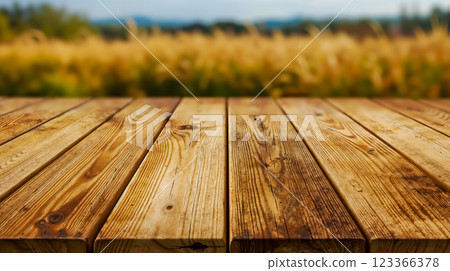 A wooden table in front of a field of wheat 123366378