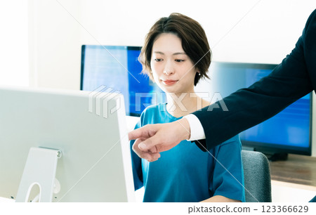 Businesswoman receiving advice from her boss Businesswoman receiving advice from her boss 123366629