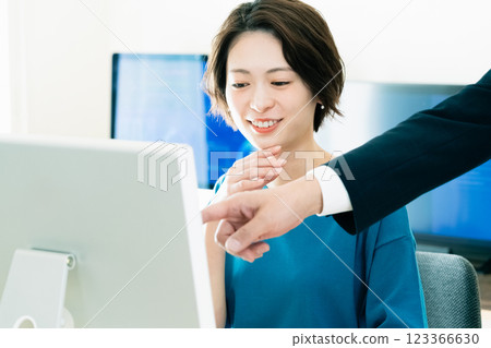 Businesswoman receiving advice from her boss Businesswoman receiving advice from her boss 123366630