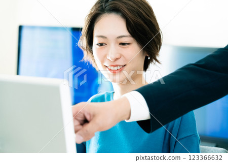 Businesswoman receiving advice from her boss Businesswoman receiving advice from her boss 123366632