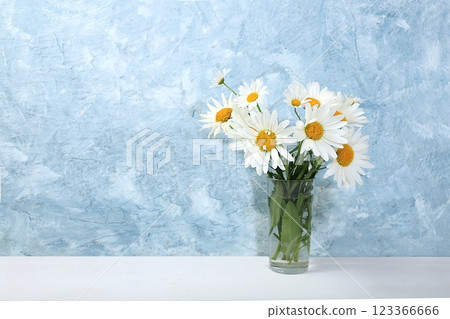 Bouquet with daisies in a vase.Abstract flower composition, autumn background, minimal holiday concept. Mother's day card, happy birthday, wedding, place for text, selective focus 123366666
