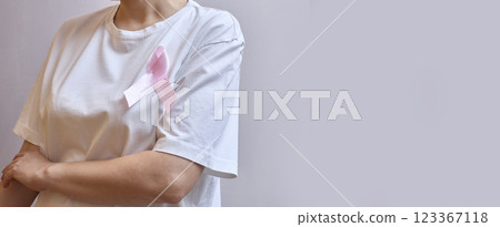 Faceless Woman With A Pink Ribbon About Breast The Concept of Breast Cancer Awareness Month. Copy space banner Faceless Woman With A Pink Ribbon About Breast The Concept of Breast Cancer Awareness Month. Copy space banner 123367118