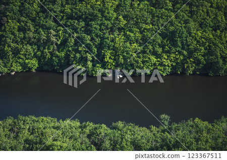 A Serene River That Is Beautifully Surrounded by Lush Greenery and Idyllic Natural Landscapes A Serene River That Is Beautifully Surrounded by Lush Greenery and Idyllic Natural Landscapes 123367511