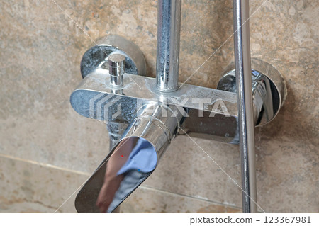 Dirty faucet with salt deposits from water in bathroom on marble modern dark tile. Cleanliness and cleaning. Caring for house and order. Lifestyle. Dirty faucet with salt deposits from water in bathroom on marble modern dark tile. Cleanliness and cleaning. Caring for house and order. Lifestyle. 123367981
