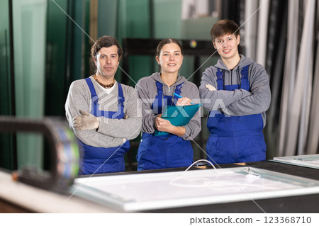 Two men and woman working in glass factory Two men and woman working in glass factory 123368710