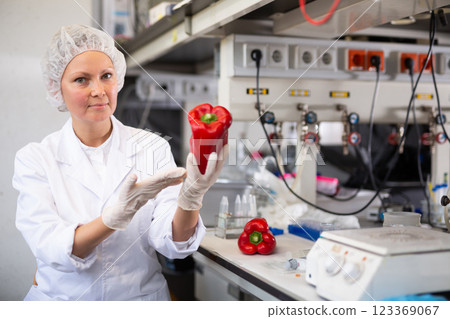 Woman lab technician analyzing pepper in laboratory Woman lab technician analyzing pepper in laboratory 123369067
