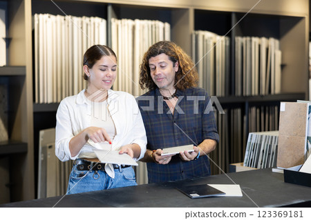 Husband and wife shopping for bathroom tiles together in hardware store Husband and wife shopping for bathroom tiles together in hardware store 123369181