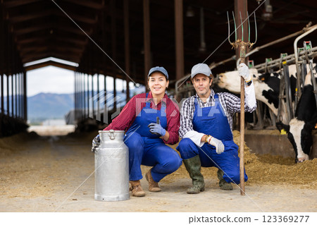Portrait of man and woman farmers on dairy farm Portrait of man and woman farmers on dairy farm 123369277