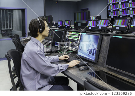 A director working in a TV station's control room. Filming cooperation: SKY Perfect TV Tokyo Media Center 123369286