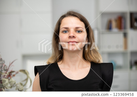 Portrait of positive smiling businesswoman in office 123369458