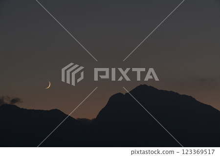 Hakushu Town, Hokuto City, Mount Kaikoma in the Southern Alps, a thin moon setting at dusk 123369517