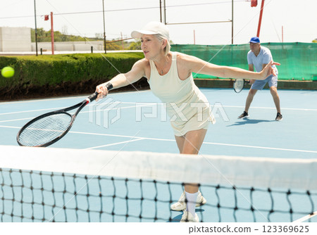 Senior woman plays tennis 123369625