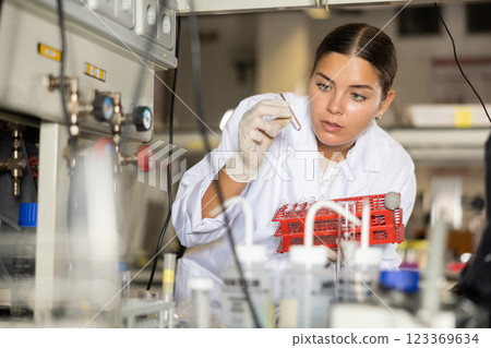 Focused female technician working in research laboratory 123369634