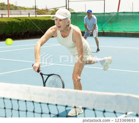 Senior woman plays tennis Senior woman plays tennis 123369693