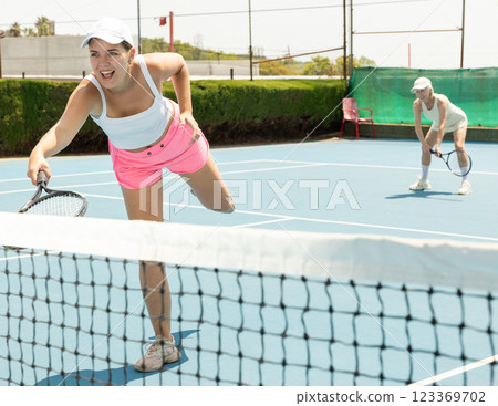 Woman playing tennis on court. Racket sport training outdoors Woman playing tennis on court. Racket sport training outdoors 123369702