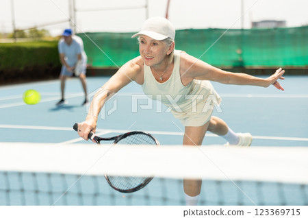 Senior woman plays tennis Senior woman plays tennis 123369715