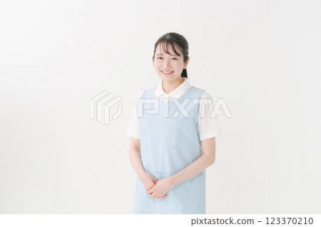 Caregiver in apron Caregiver in apron 123370210