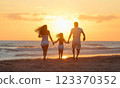 Family silhouette on the beach at sunset 123370352