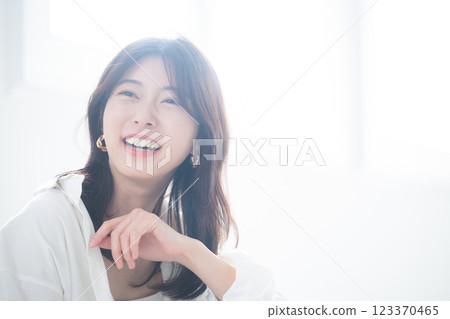 Close-up portrait of a stylish woman wearing earrings in backlight 123370465