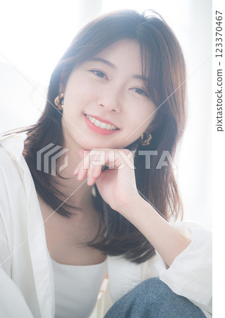 Close-up portrait of a stylish woman wearing earrings in backlight 123370467