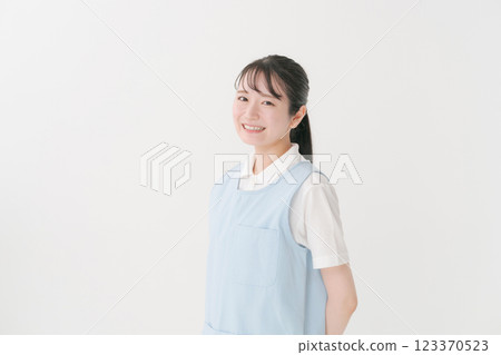 A caregiver in his 20s wearing an apron A caregiver in his 20s wearing an apron 123370523