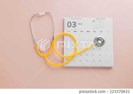 Doctor Day design with calendar and yellow stethoscope on pink. A theme promoting annual checkups 123370632