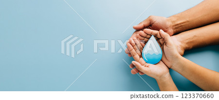 Celebrate World Water Day. Two hands cradle a water drop cutout, highlighting clean water, hygiene 123370660