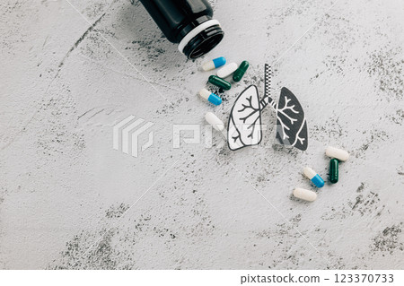 Lungs pills and medicine bottle represent World TB Day on gray background. Lungs pills and medicine bottle represent World TB Day on gray background. 123370733