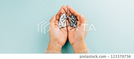 Lungs paper held by two hands represents World TB Day. Raising awareness about tuberculosis 123370736