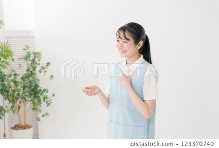 Caregiver in apron 123370740