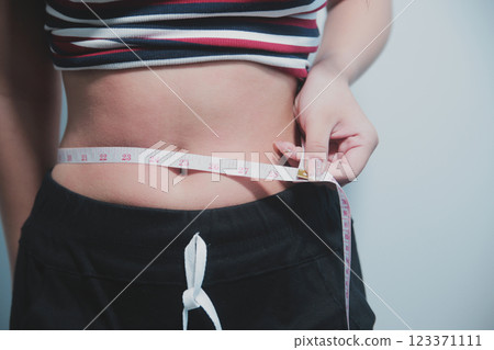 Women body fat belly. Obese woman hand holding excessive belly fat. diet lifestyle concept to reduce belly and shape up healthy stomach muscle. Women body fat belly. Obese woman hand holding excessive belly fat. diet lifestyle concept to reduce belly and shape up healthy stomach muscle. 123371111