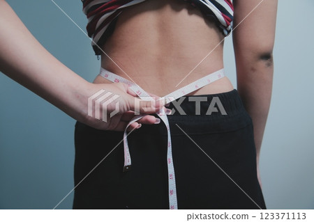 Women body fat belly. Obese woman hand holding excessive belly fat. diet lifestyle concept to reduce belly and shape up healthy stomach muscle. Women body fat belly. Obese woman hand holding excessive belly fat. diet lifestyle concept to reduce belly and shape up healthy stomach muscle. 123371113