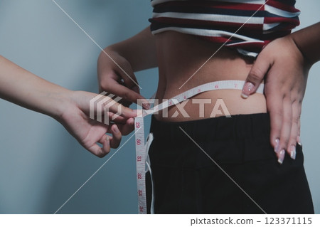 Women body fat belly. Obese woman hand holding excessive belly fat. diet lifestyle concept to reduce belly and shape up healthy stomach muscle. Women body fat belly. Obese woman hand holding excessive belly fat. diet lifestyle concept to reduce belly and shape up healthy stomach muscle. 123371115